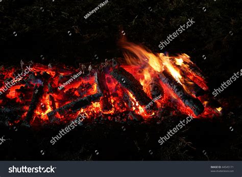 Ember magic ignites a blaze built in a charcoal barbecue
